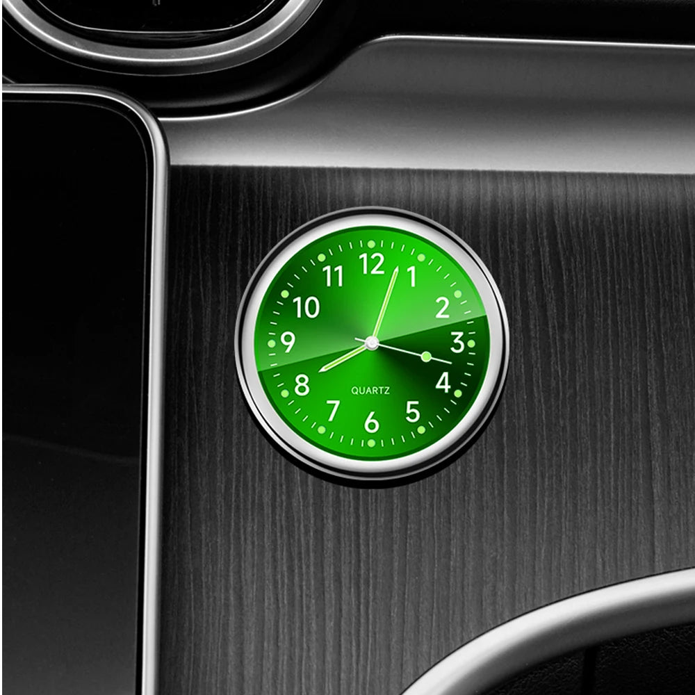 Green clock on a car interior metallic surface