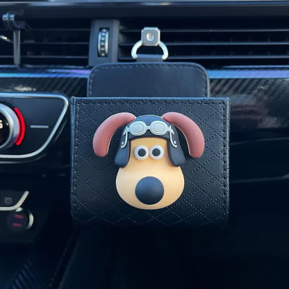 Black car dog bag with a dog design hanging from a car's air vent.