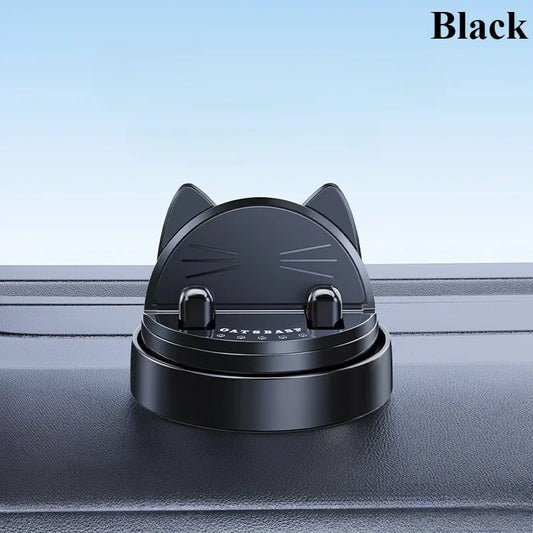 Black cat-shaped phone stand on a car dashboard with a light blue background