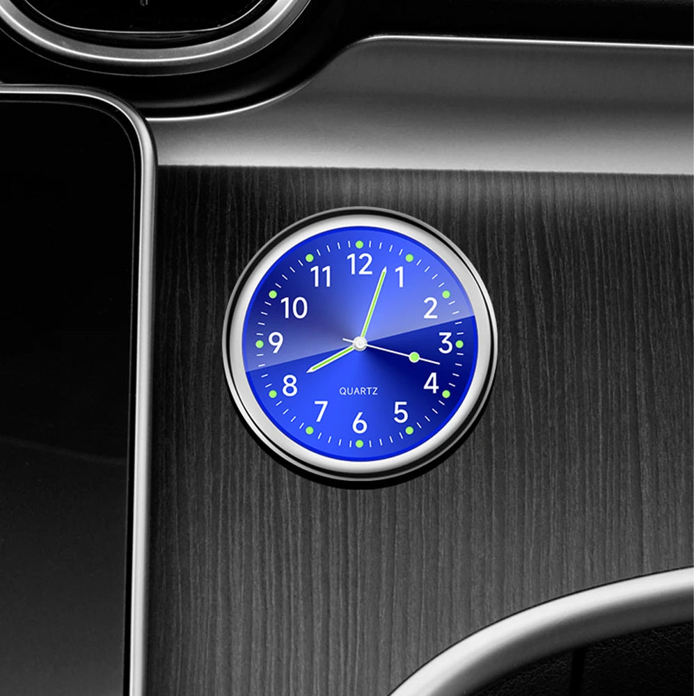 Blue clock with silver frame on a metallic surface