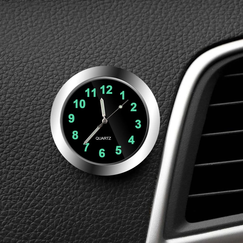 Car dashboard clock with green digital numbers on a black leather surface