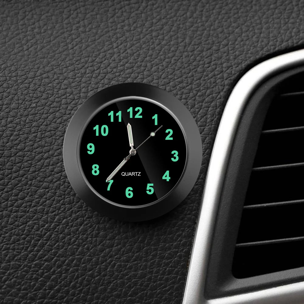 Car dashboard clock with green glowing numbers on a black leather surface.