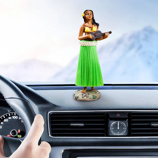 Car dashboard with a figurine of a woman in a green dress and yellow top, holding a guitar.