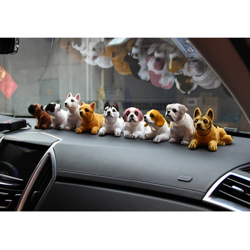 Car dashboard with toy dog figurines arranged in a row