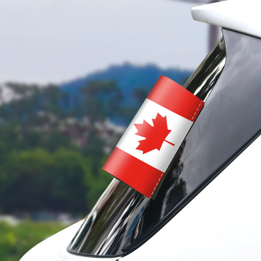Car exhaust with a Canadian flag decal against a blurred outdoor background