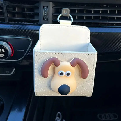 Car organizer with a dog design attached to a car's air vent.