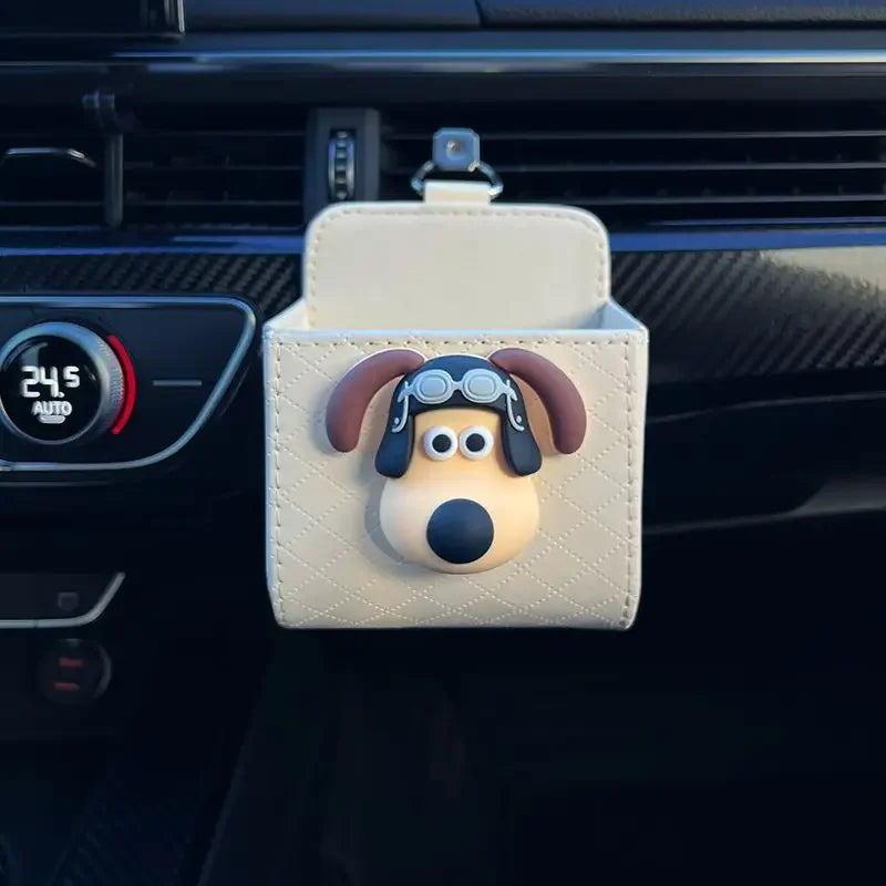 Car organizer with dog design attached to a car's air vent.