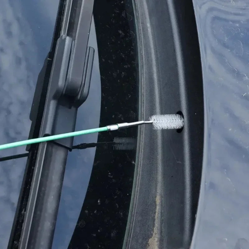 Car windshield wiper blade with a cleaning tool on a car window