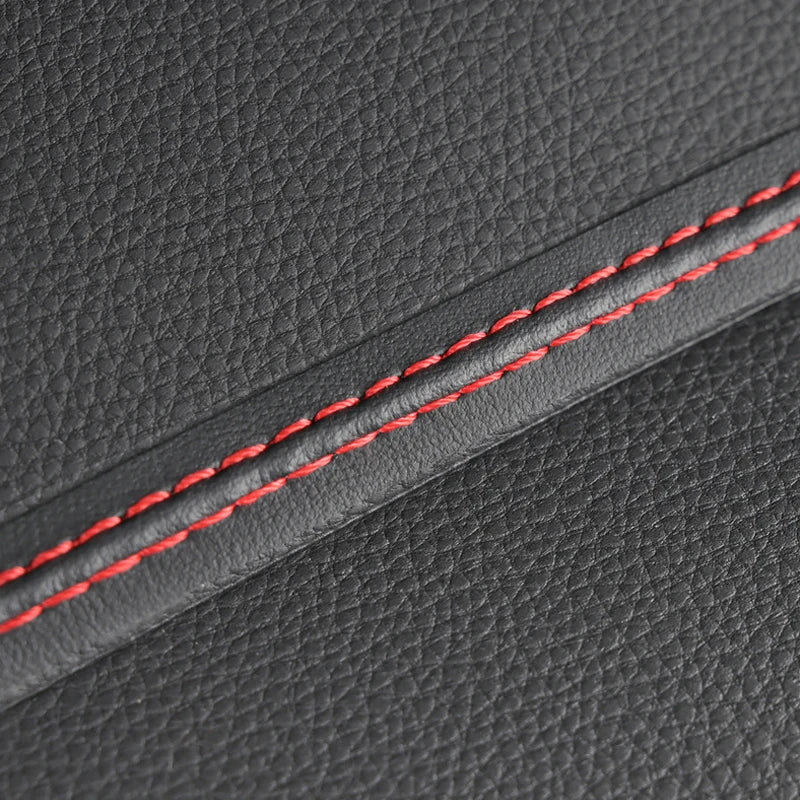 Close-up of gray leather with red stitching