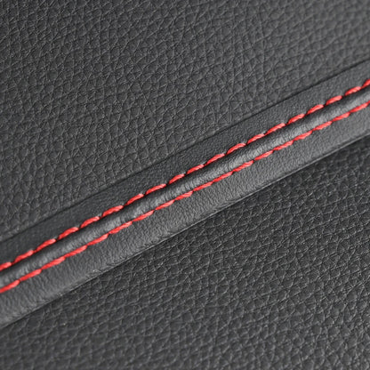Close-up of gray leather with red stitching