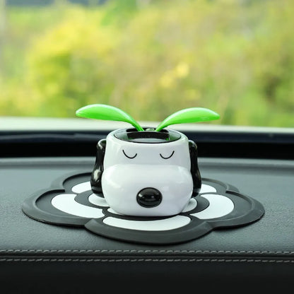 Cute cartoon character with green leaves on a car dashboard