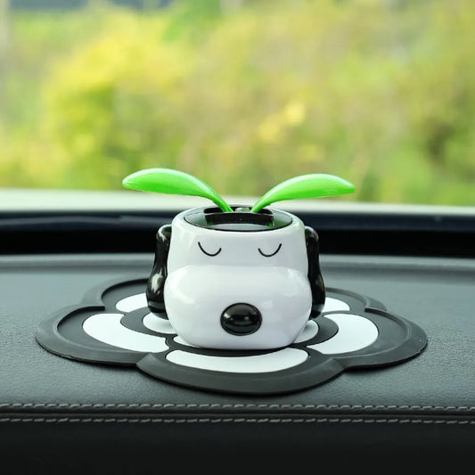 Cute cartoon character with green leaves on a car dashboard