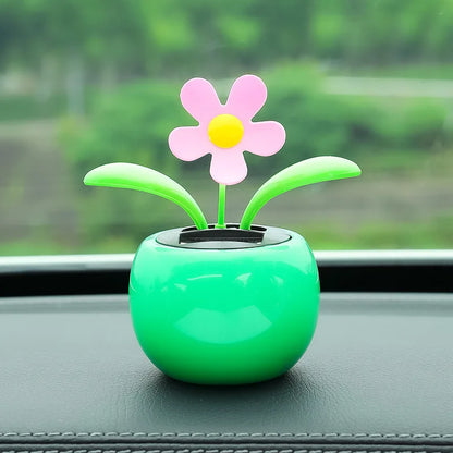 Decorative flower on a car dashboard with a blurred green background