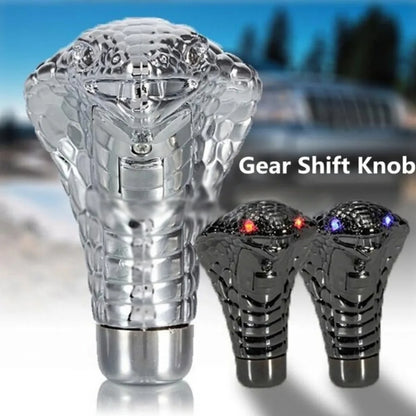 Decorative gear shift knob with LED lights on a blurred vehicle background