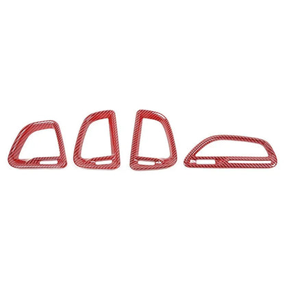 Four red metal stirrups on a white background