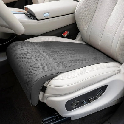 Gray car seat cover on a white car seat with visible stitching details.