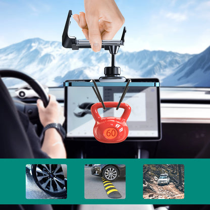 Hand holding a tablet with a car mount displaying a kettlebell on a mountain road.
