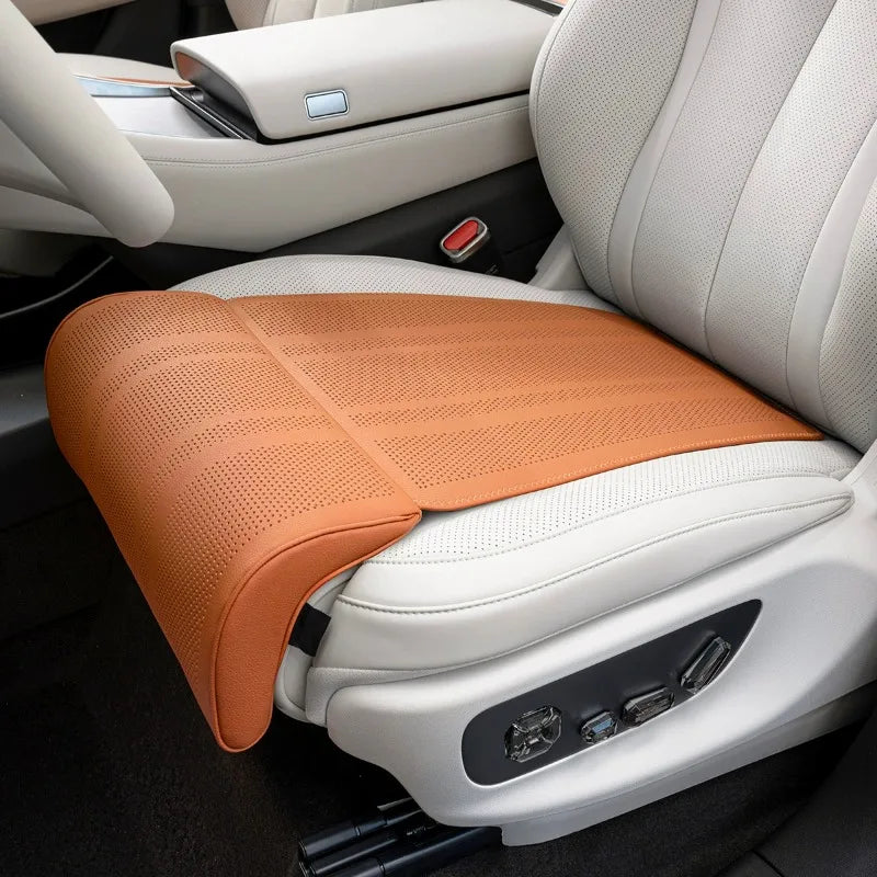 Orange car seat cushion on a white car seat