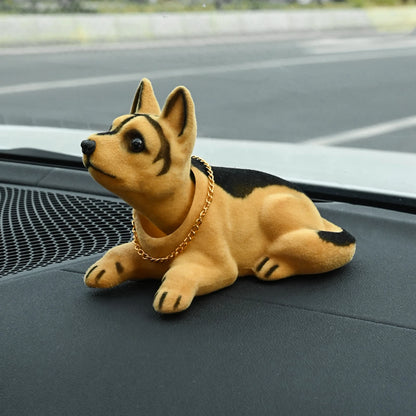 Plush toy dog with a gold chain on a car dashboard