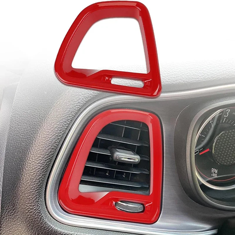 Red car air vent cover on a vehicle dashboard