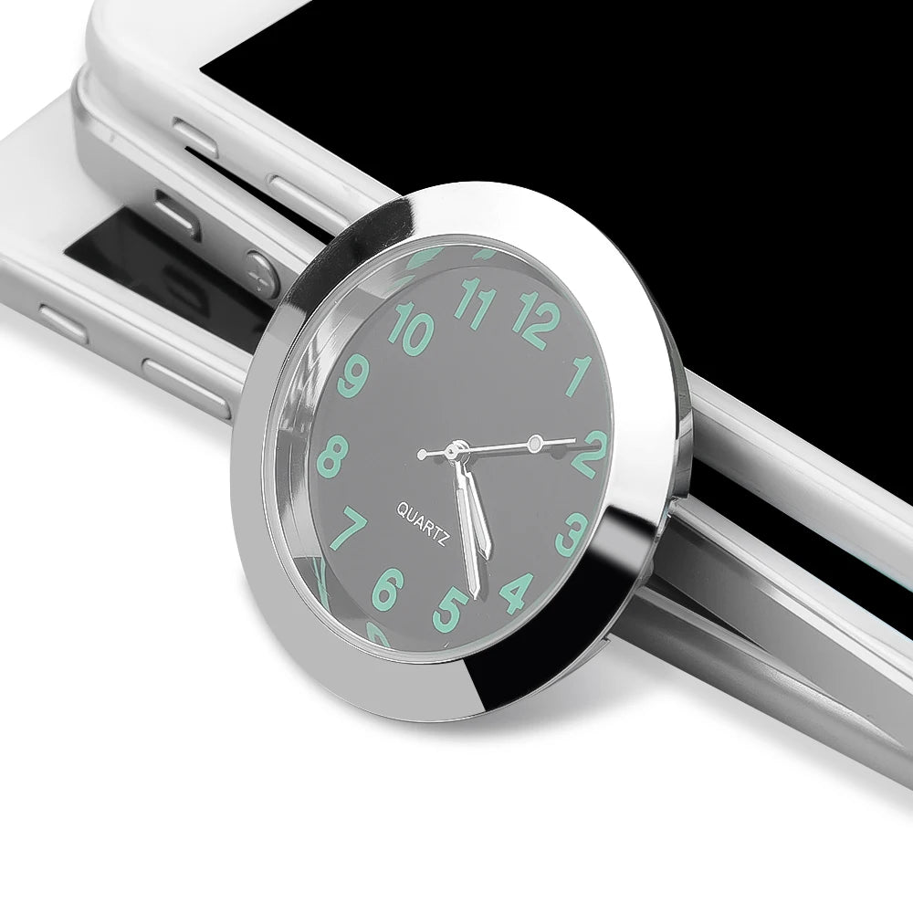 Silver watch with green-tinted face on a smartphone