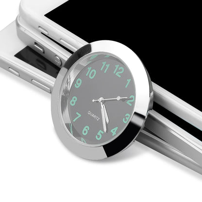 Silver watch with green-tinted face on a smartphone