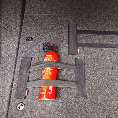 Two red fire extinguishers secured with straps 