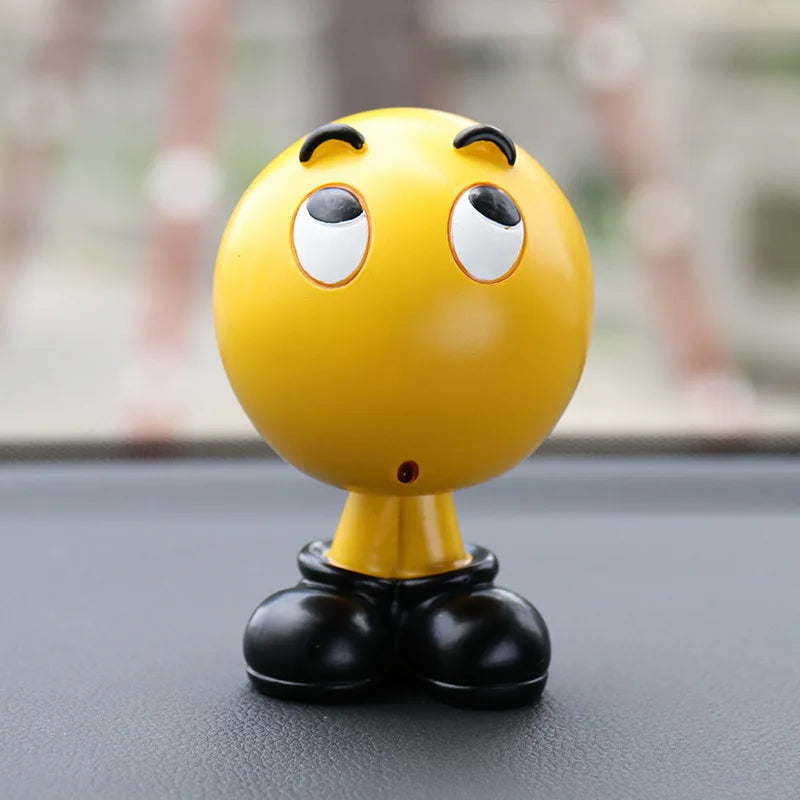 Yellow character figurine with black shoes on a reflective surface