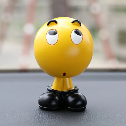 Yellow character figurine with black shoes on a reflective surface