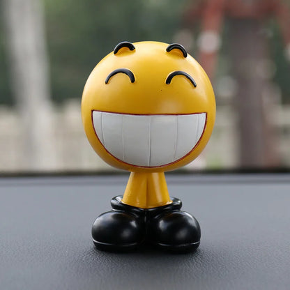 Yellow smiley face figurine with black shoes on a reflective surface